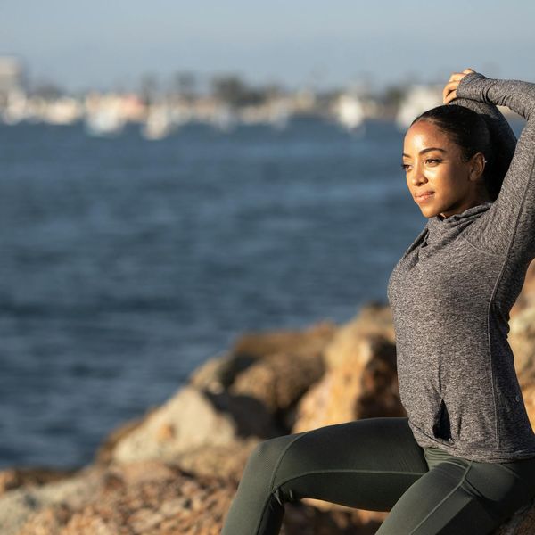 Person stretching energetically during a sunrise yoga session.